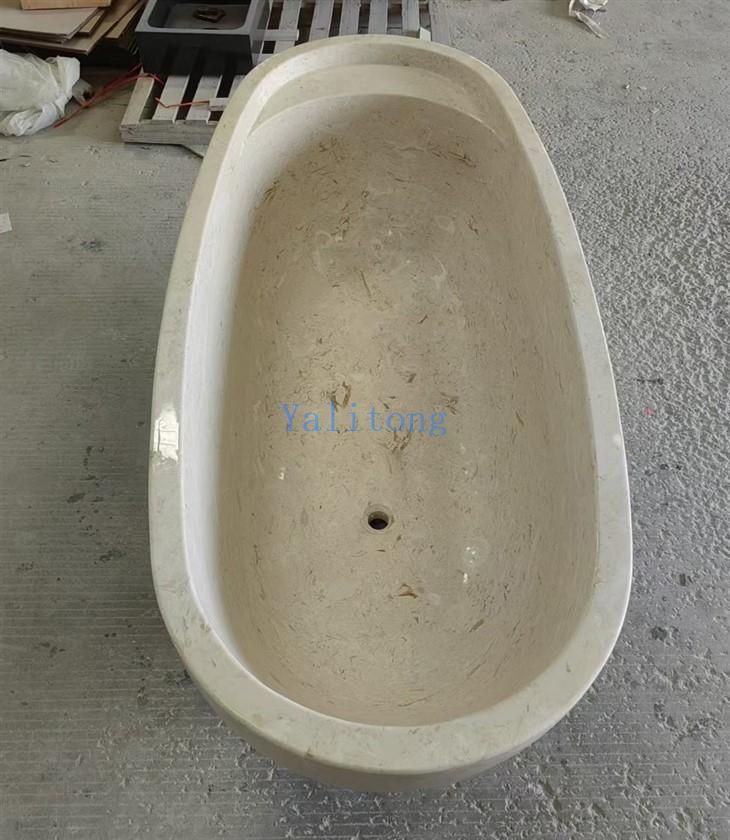 beige limestone bathtub